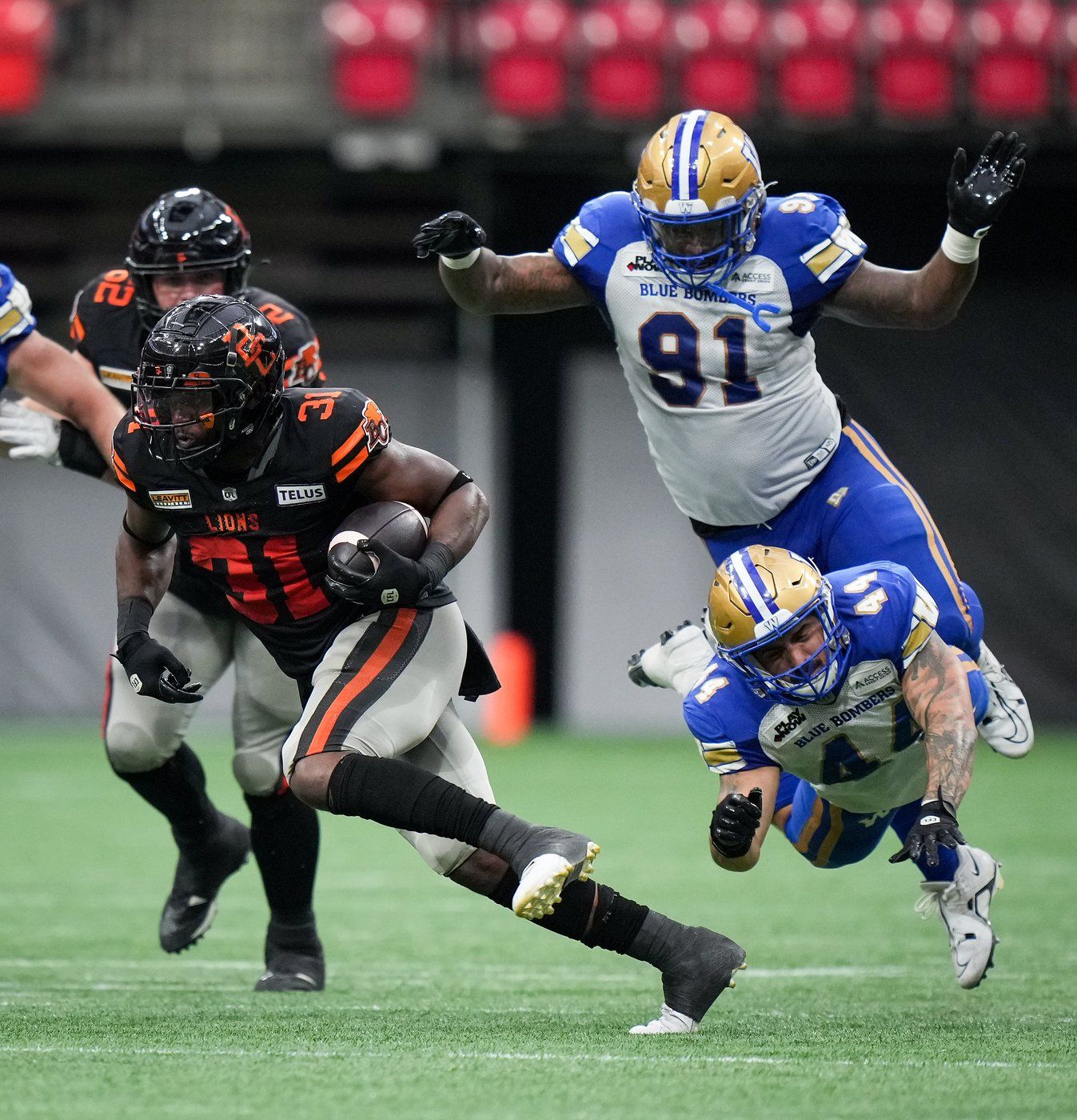 B.C. Lions' William Stanback (31) avoids a tackle by Winnipeg Blue Bombers' Shayne Gauthier (44) as he carries the ball during the first half of a CFL football game, in Vancouver, B.C., Sunday, Aug. 18, 2024. THE CANADIAN PRESS/Darryl Dyck