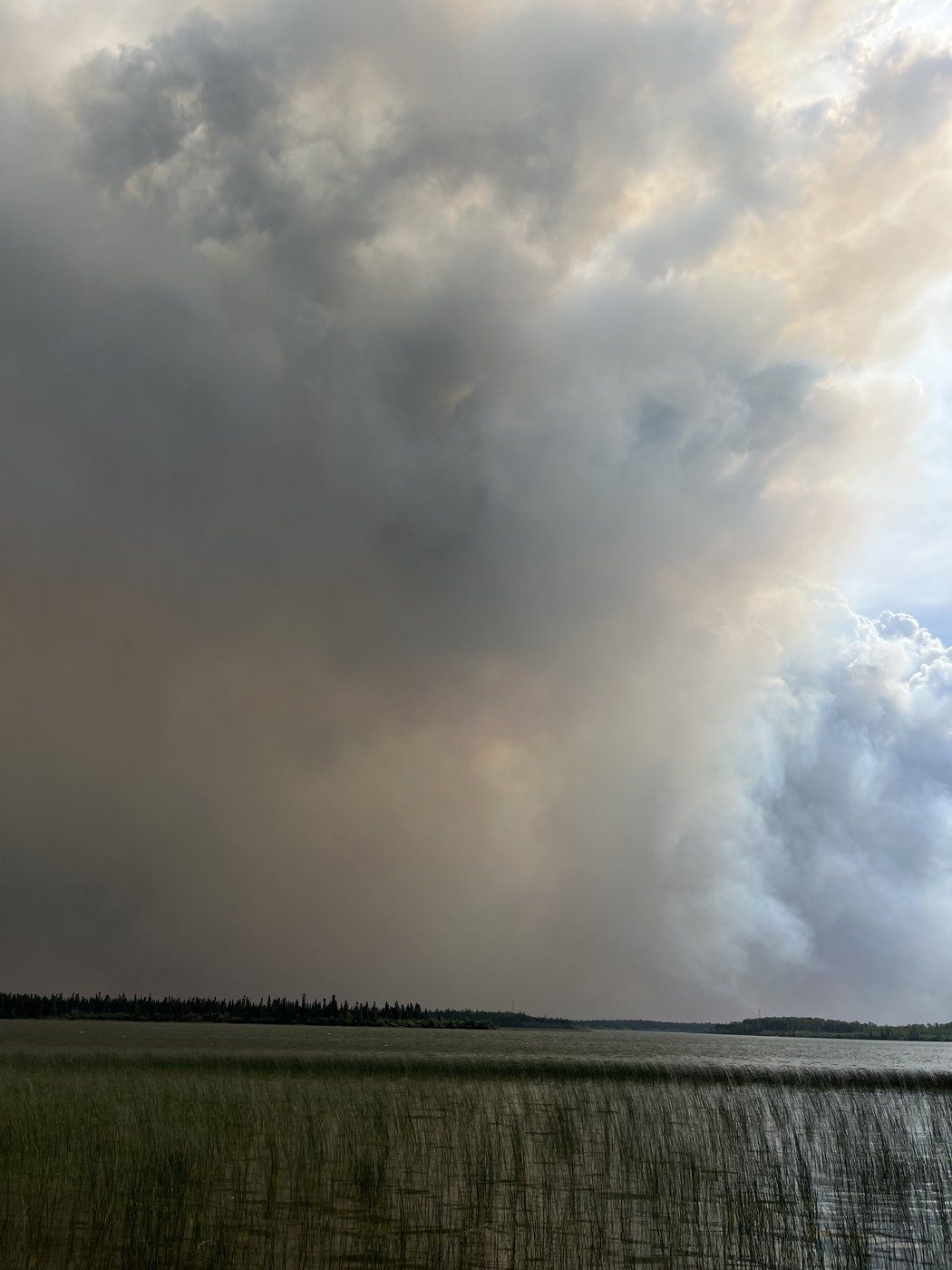 A wildfire burns near Oxford House, Man., in a Aug. 13, 2024 handout photo. The Canadian Red Cross says it's supporting more than 2,300 people from the Bunibonibee Cree Nation. THE CANADIAN PRESS/HO - Richard Hart *MANDATORY CREDIT*