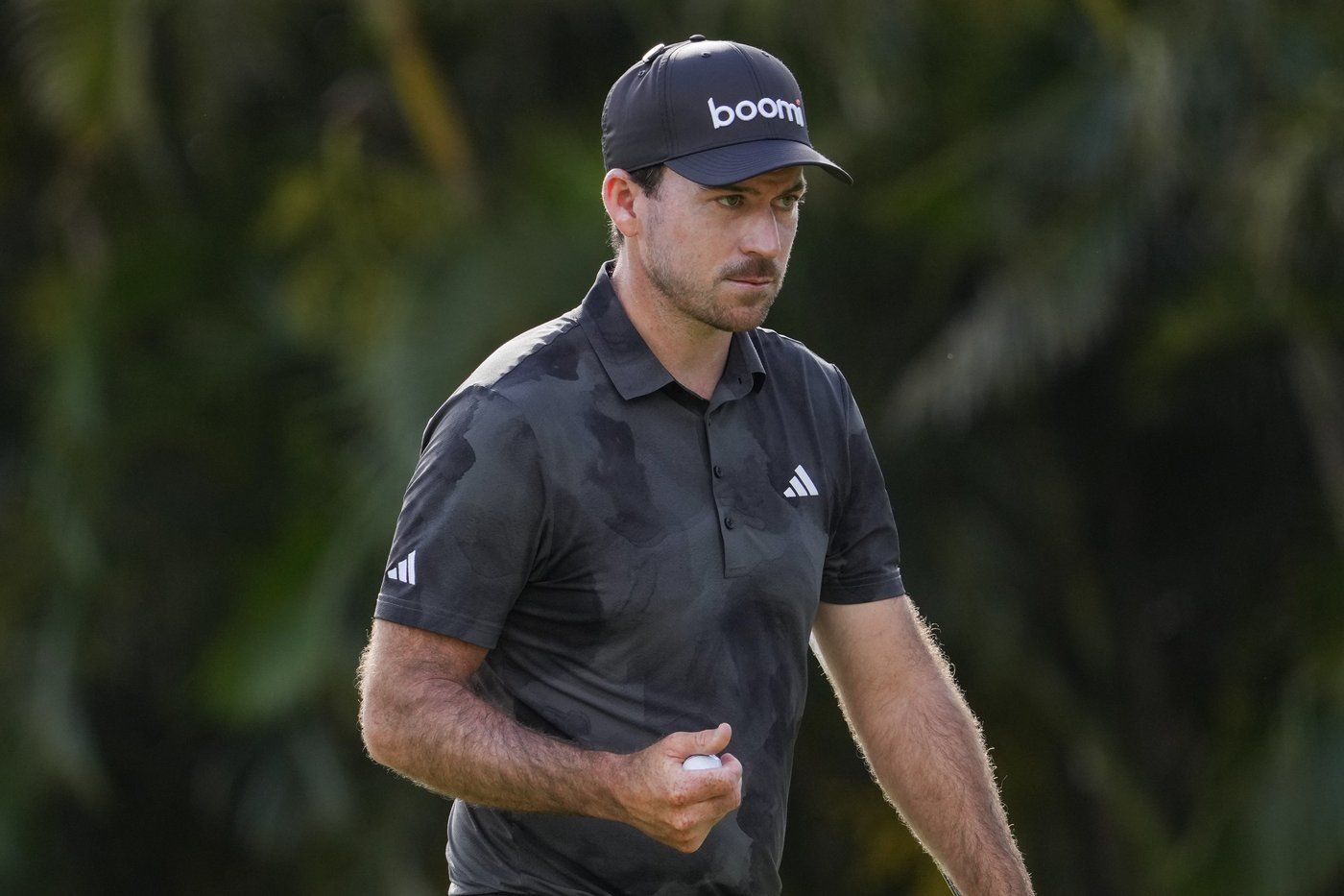 Nick Taylor, of Canada, reacts after making a shot on the first green during the final round of the Sony Open golf event, Sunday, Jan. 12, 2025, at Waialae Country Club in Honolulu. (AP Photo/Matt York)