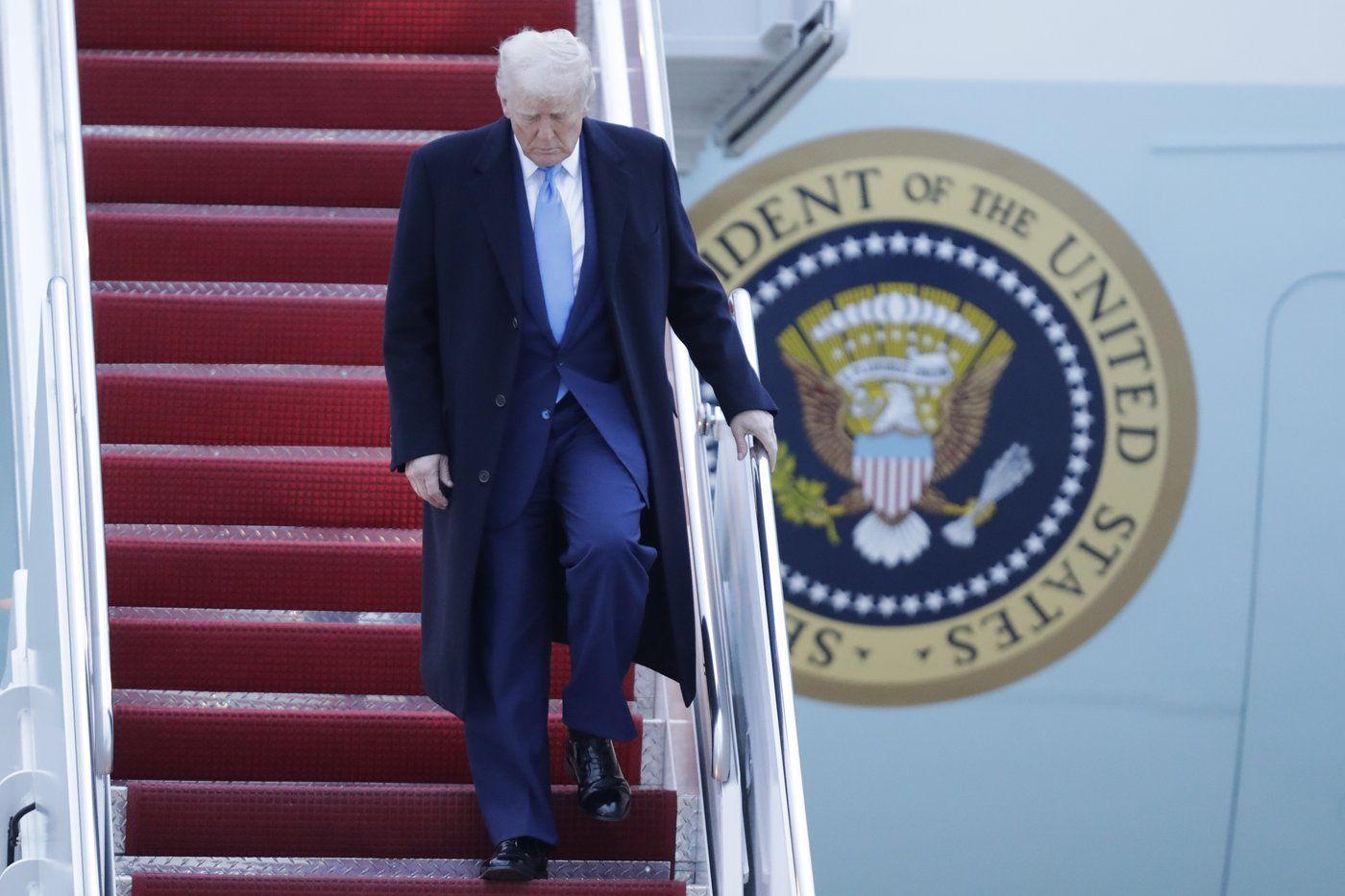 President Donald Trump walks down the stairs of Air Force One upon his arrival at Joint Base Andrews, Md., Sunday, April 6, 2025. (AP Photo/Luis M. Alvarez)