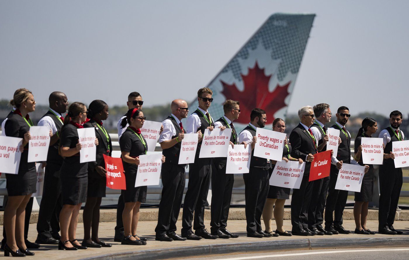 Air Canada flight attendants hold a silent protest at Montreal-Pierre Elliott Trudeau International Airport in Montreal on Monday, Aug. 11, 2025. THE CANADIAN PRESS/Christinne Muschi