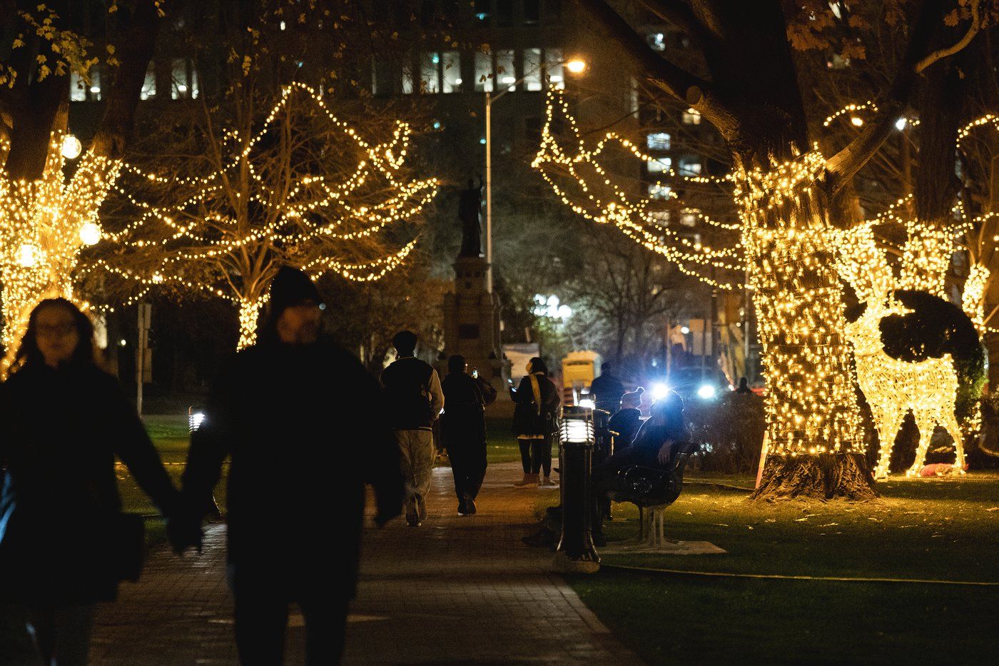 Visitors to Queen's Park, the Ontario provincial legislature, walk amid the front lawn's holiday decorations, in Toronto, Friday, Nov. 21, 2025. THE CANADIAN PRESS/Giordano Ciampini